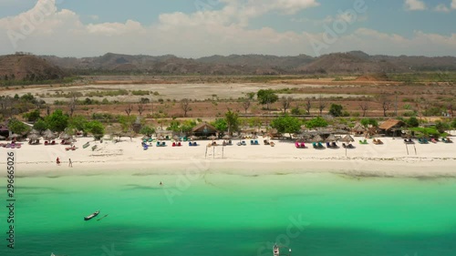 The white sand beach of Tanjung Aan in Lombok, Indonesia during a sunny day. Aerial shot. photo