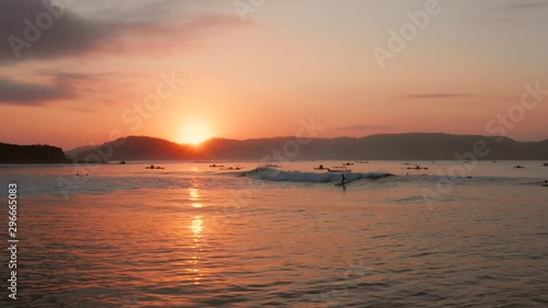 Sunrise at the surf spots of Gerupuk in Lombok, with a view on the bay with the fishing boats and surfers. Aerial shot. photo