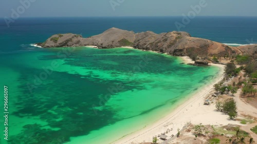 The white sand beach of Tanjung Aan in Lombok, Indonesia during a sunny day. Aerial shot. photo