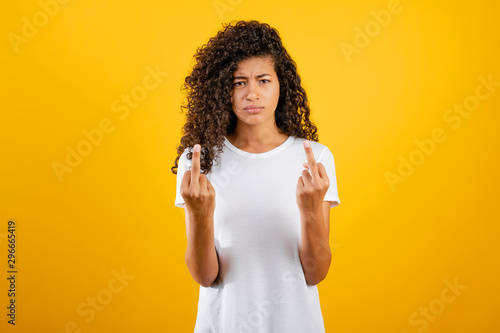 black african woman showing middle finger isolated over yellow