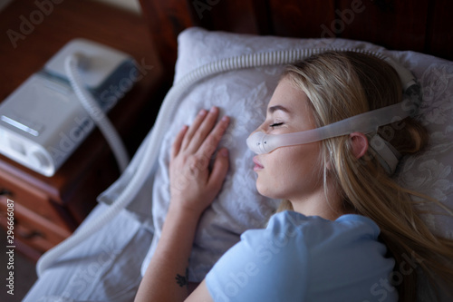 Young person, sleeping with cpap machine. © Hope
