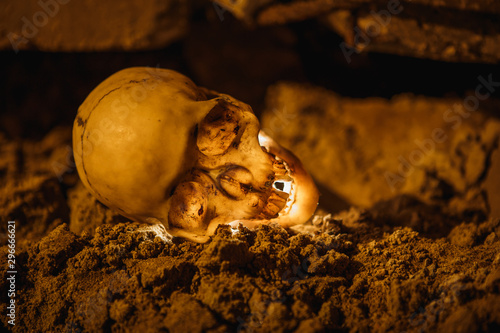 The light on the ground in the dark basement glows yellow from the inside. Terrible picture of a layout of a skull for Halloween.