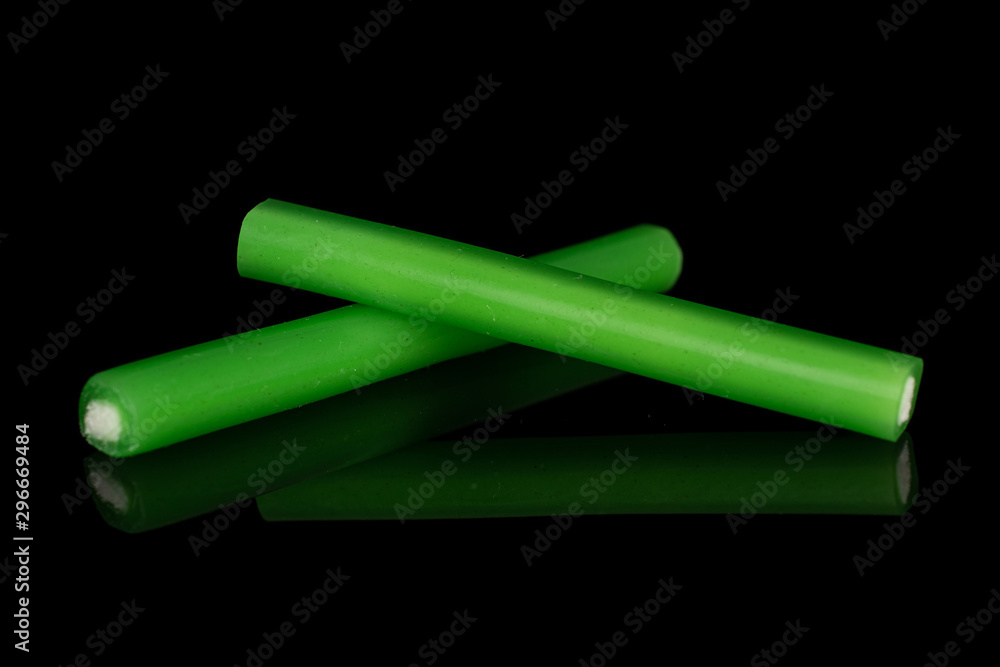 Group of two whole sweet stick candy isolated on black glass Group of two whole sweet stick candy isolated on black glass