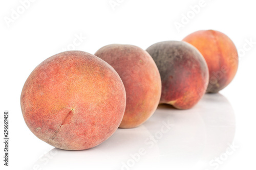 Group of four whole sweet red peach in diagonal isolated on white background