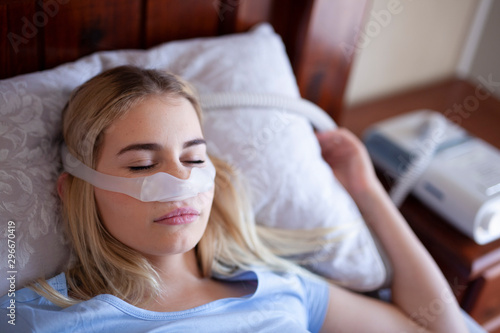 Cpap machine, sleeping with cpap mask under nose photo