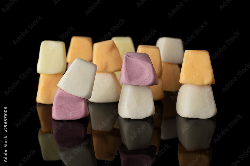Lot of whole arranged soft pastel candy isolated on black glass Lot of whole arranged soft pastel candy isolated on black glass