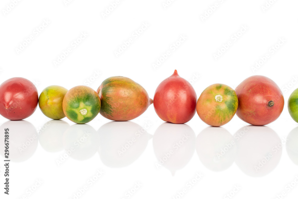 Group of seven whole fresh tomato de barao isolated on white background Group of seven whole fresh tomato de barao isolated on white background