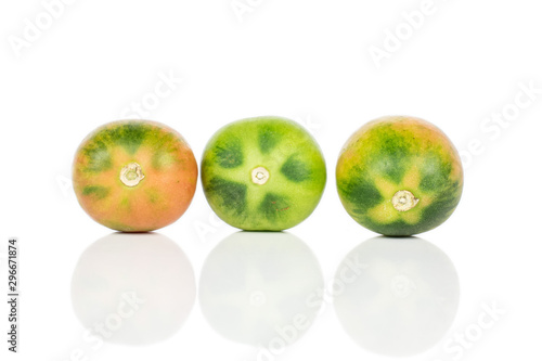 Group of three whole unripe fresh tomato de barao isolated on white background photo