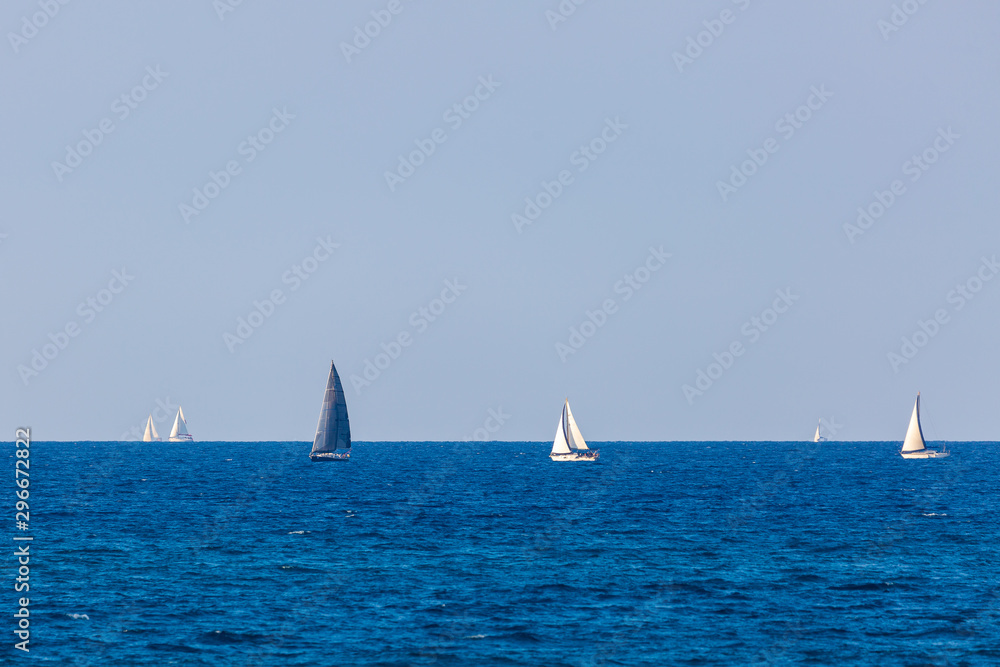 Several yacht with white and gray sail on Mediterranean Sea