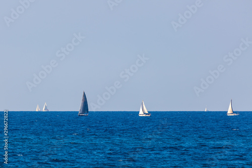 Several yacht with white and gray sail on Mediterranean Sea