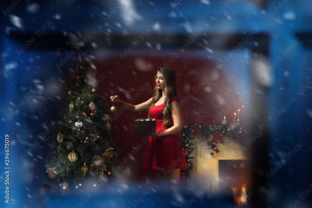 portrait of nice woman in red dress decorating christmas tree portrait of nice woman in red dress decorating christmas tree