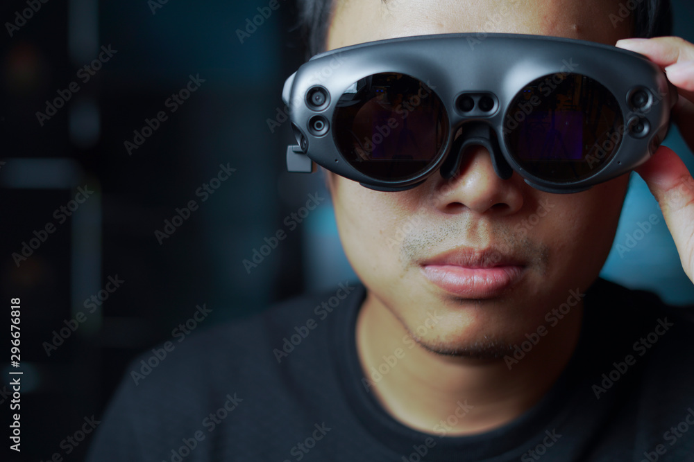 close up man wearing AR glasses in a dark room close up man wearing AR glasses in a dark room