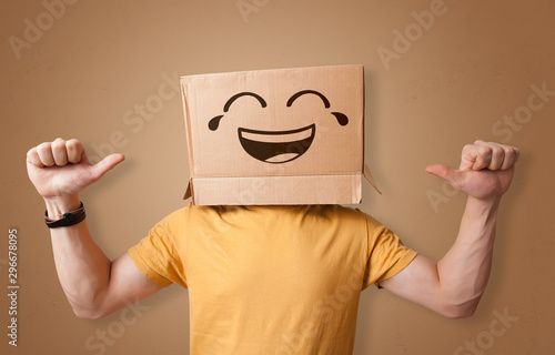 Funny man wearing cardboard box on his head with smiley face