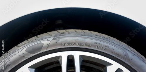 Close up of Number code on sidewall of car tyre with alloy wheel, Tyre Sidewall Markings.	 photo
