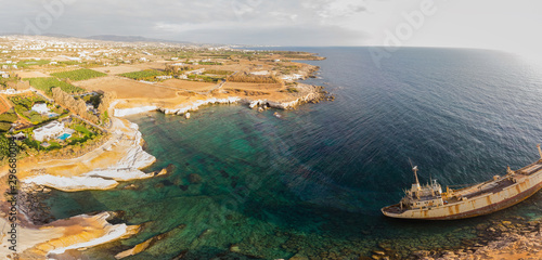 Aerial view of the abandoned ship EDRO III in Pegea, Paphos, Cyprus. Rusty shipwreck stranded on the rocks in intercostal Peyia sea caves, coral Bay, Paphos, standing at an angle to the shore. photo