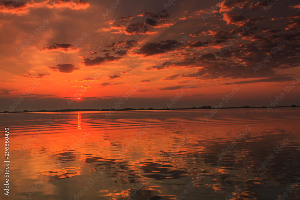 Beautiful sunrise colors and water reflections in the Danube Delta, Romania, in spring