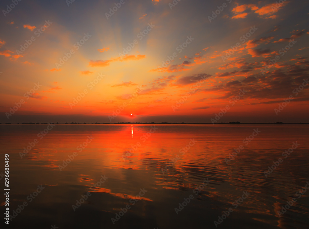 Beautiful sunrise colors and water reflections in the Danube Delta, Romania, in spring