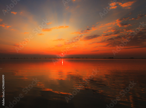 Beautiful sunrise colors and water reflections in the Danube Delta, Romania, in spring © Calin Tatu