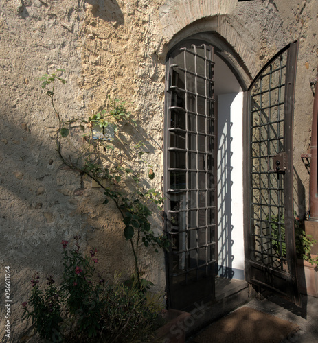 Wrought-iron portal to Tuscan villa, Monteseprtoli photo