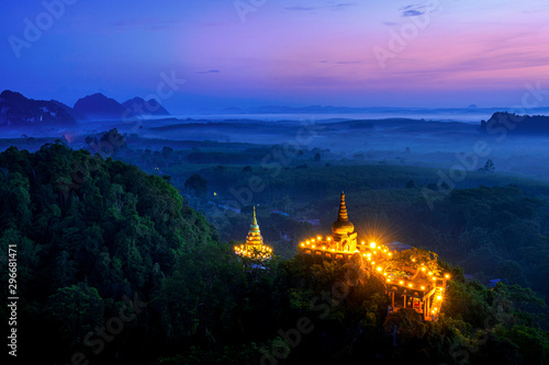 Khao Na Nai Luang Tham Park. Pagoda at sunrise on the top at Khao Na Nai Luang Dharma Park with fog. Beautiful Temple at Surat Thani province, Thailand. © Thirawatana