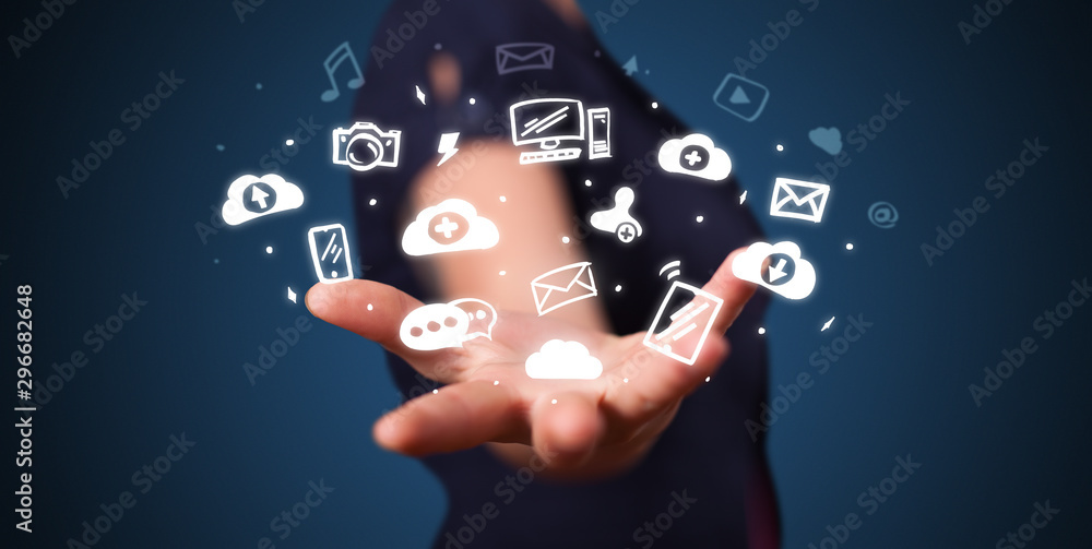 Hand holding application icons and symbols in her hand Hand holding application icons and symbols in her hand