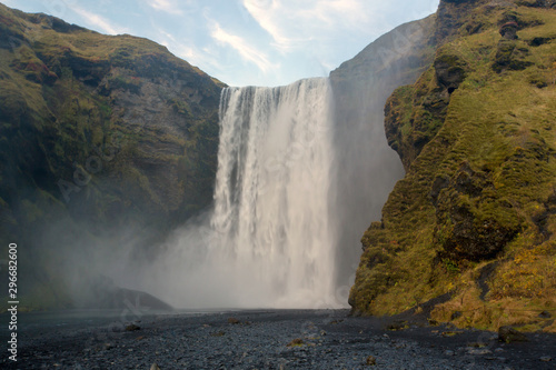 Beautiful view of the Skogafoss waterfall in Iceland on a sunset cloudy day