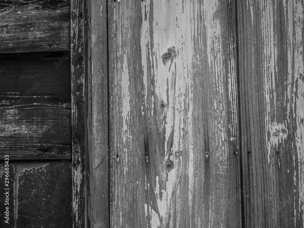 Abstract black and white tone of old cracked wooden wall texture and background with vertical and horizontal striped pattern. Abstract black and white tone of old cracked wooden wall texture and background with vertical and horizontal striped pattern.