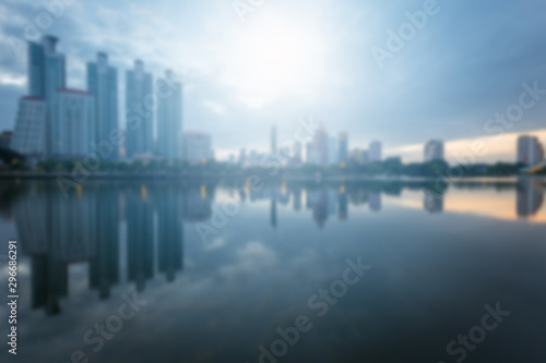 Blur City building with water reflection before sunset