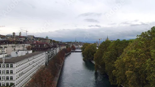 Wallpaper Mural Quick, forward moving aerial dolly shot along the Limmat river in downtown Zurich, Switzerland with lush greenery in the foreground a larger cityscape in the background Torontodigital.ca