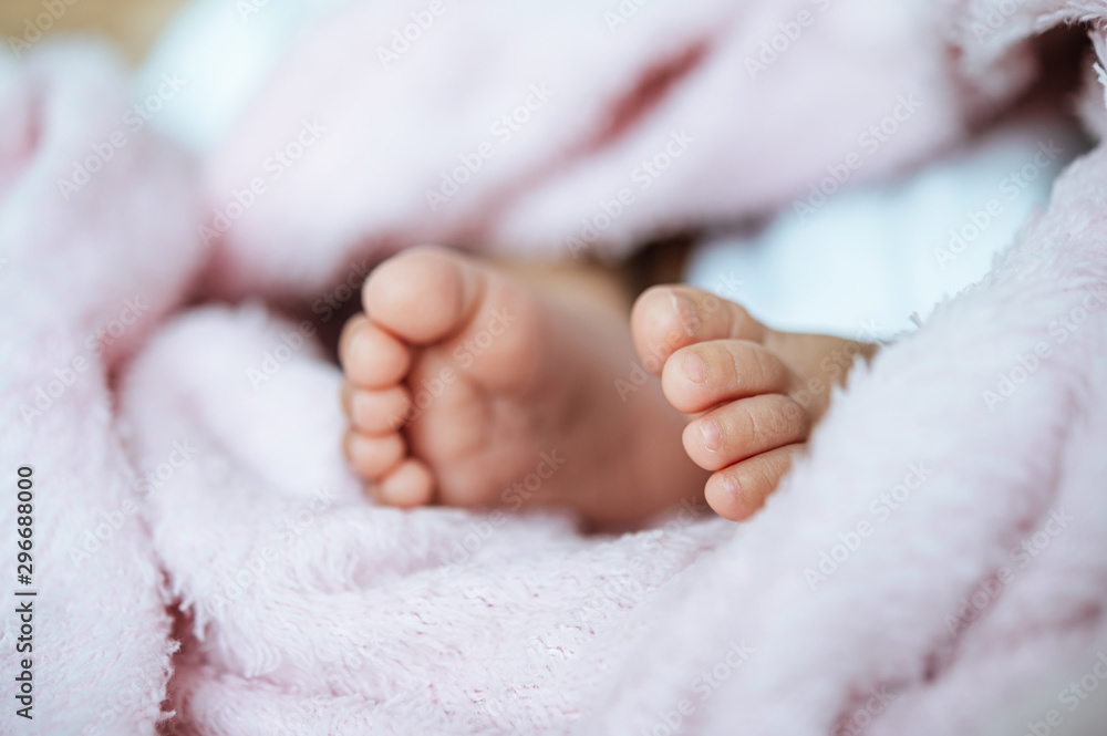 Newborn baby feet on a white blanket. Newborn baby feet on a white blanket.