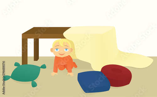 Toddler playing in a blanket fort