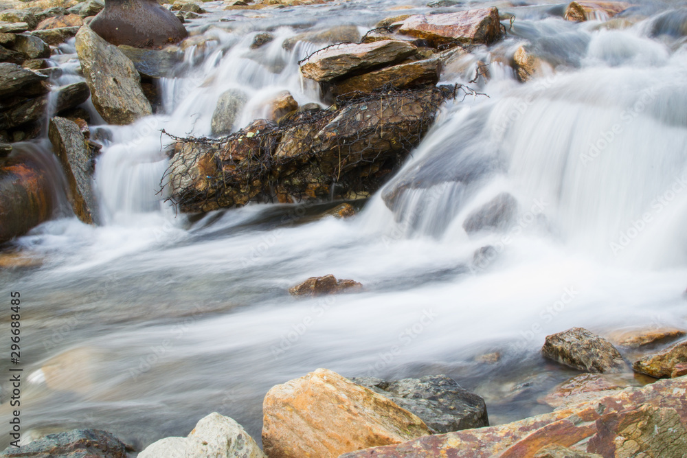Long exposure picture of small waterfalls between boulders making a brook in Snowdonia, Wales Long exposure picture of small waterfalls between boulders making a brook in Snowdonia, Wales