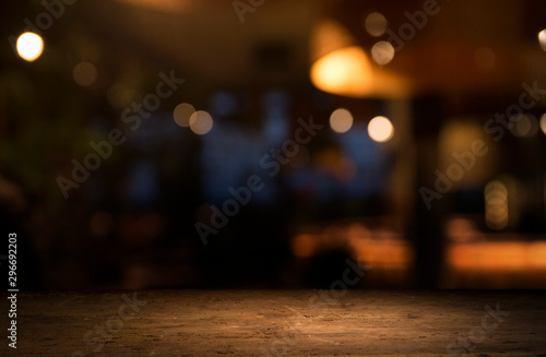 Fototapeta Empty wood table top on blur light gold bokeh of cafe restaurant in dark backgro