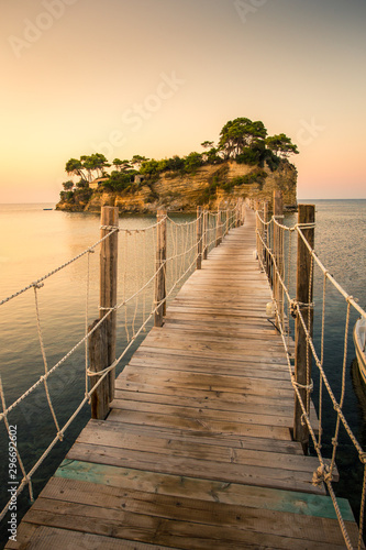 Beautiful sunrise at the famous Cameo island. A beautiful small island with wooden bridge and turquoise water. Zakynthos Greece. In summer.