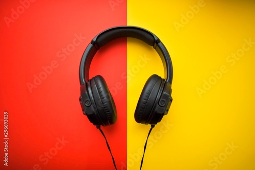 Black headphones on a red and yellow background