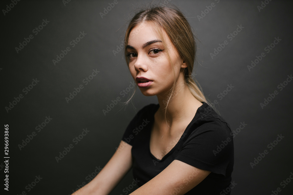 Fashion portrait of a sexy blonde woman with a make up wearing black clothes Fashion portrait of a sexy blonde woman with a make up wearing black clothes