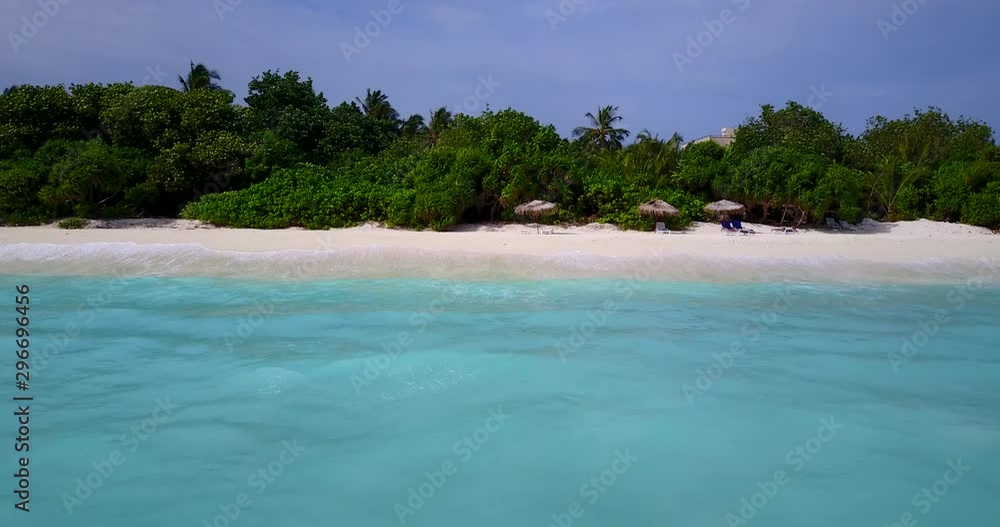 View of sandy beach of a tropical island in Malaysia, from the boat leaving to open sea View of sandy beach of a tropical island in Malaysia, from the boat leaving to open sea
