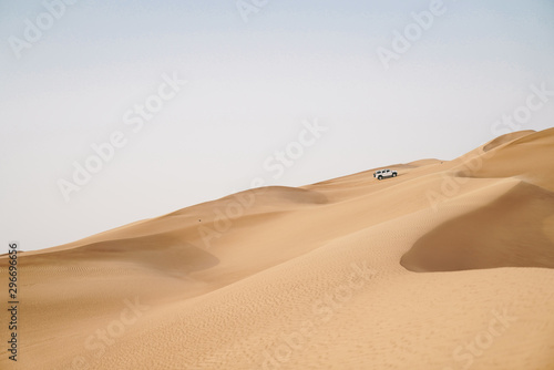 4x4 Off-road vehicle adventure in scenic view of dessert sand dunes 