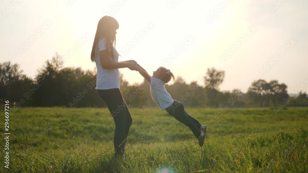 A happy little girl runs into the arms of her loving mother. The happiness of motherhood, friendship, trust, love. A happy little girl runs into the arms of her loving mother. The happiness of motherhood, friendship, trust, love.