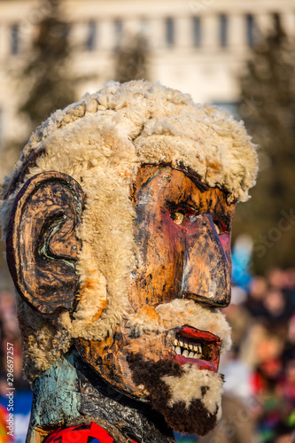 Mummers perform rituals to scare evil spirits at Surva festival at Pernik in Bulgaria. The people with the masks are called Kuker (kukeri). Wood mask with wool beard.