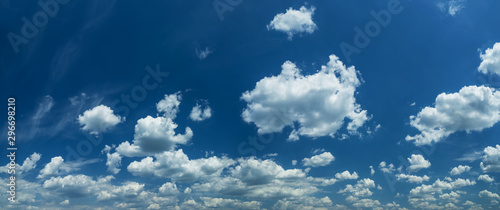 Fototapeta Naklejka Na Ścianę i Meble -  Some light cumuliform clouds in the clean blue sky.