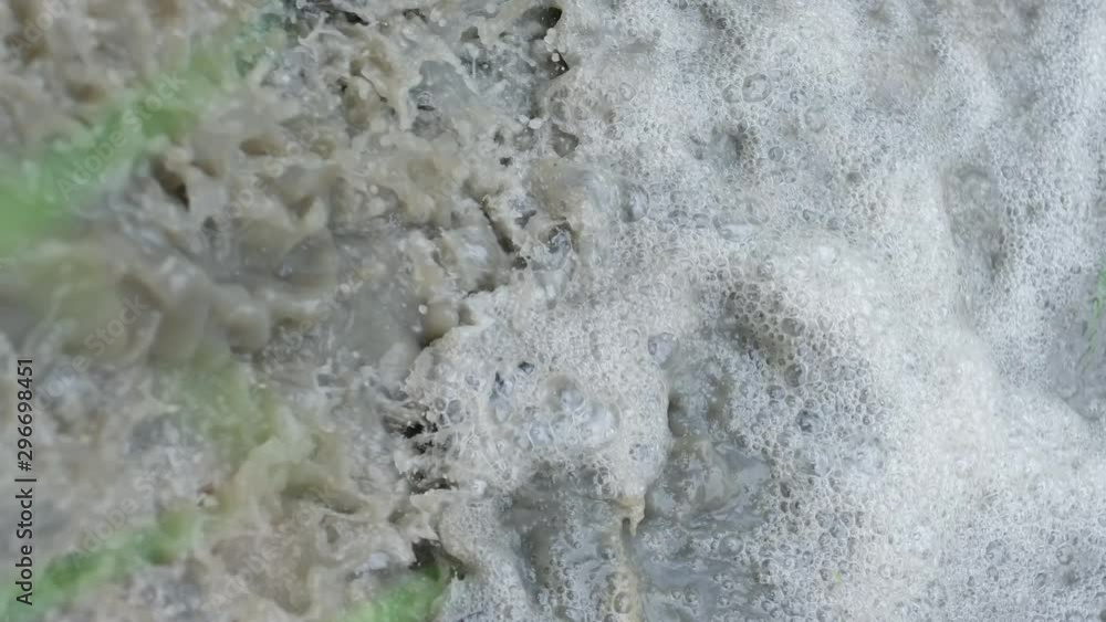 motion of mud water flowing down with bubbles . motion of mud water flowing down with bubbles .