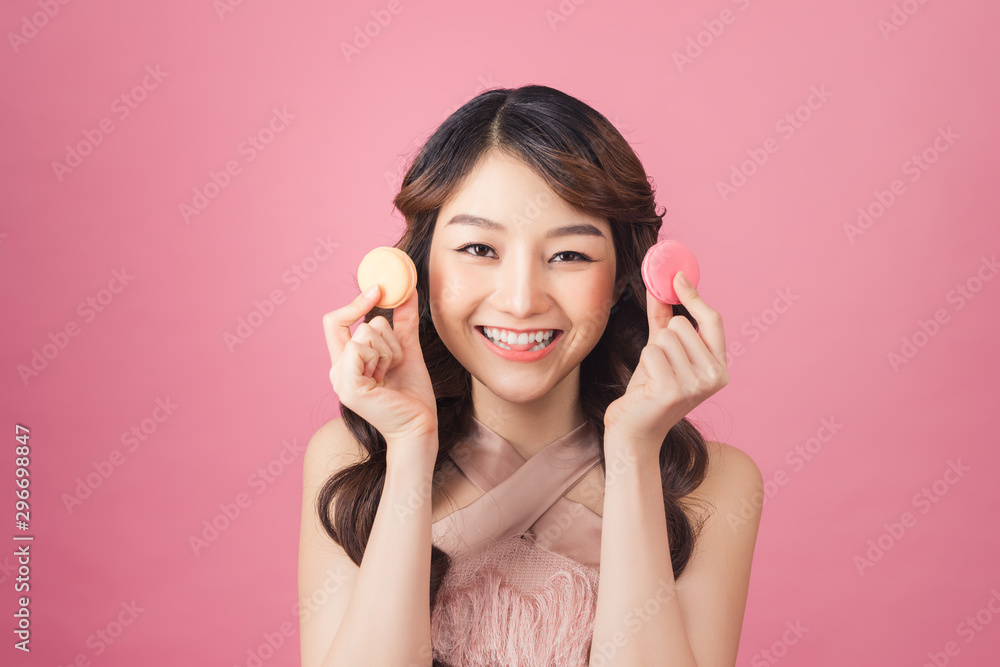 portrait of happy asian woman with macaron looking at camera portrait of happy asian woman with macaron looking at camera