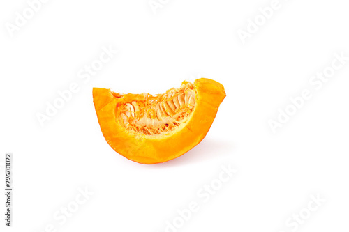 One cut piece of ripe orange pumpkin with seeds close-up isolated on a white background.