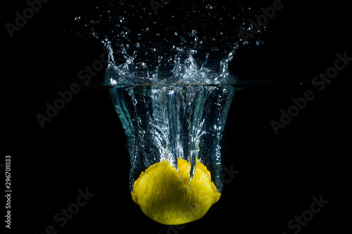 Water splash and fruits isolated on black backgroud. Fresh Lemon