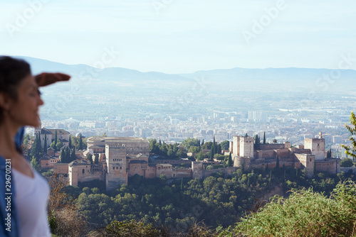  People in a viewpoint of the city of Granada contemplating beautiful views of this city.