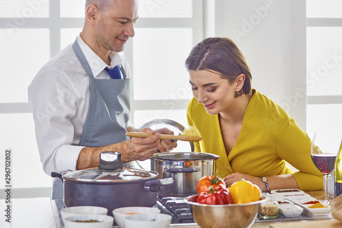 Smiling young couple cooking food in the kitchen