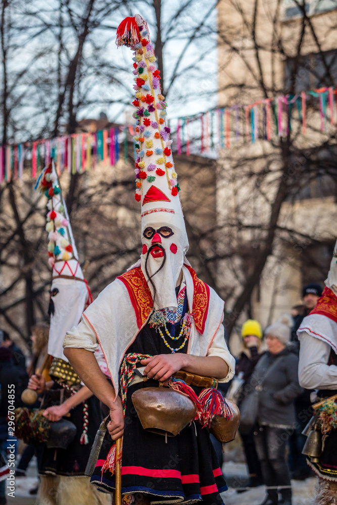 Mummers perform rituals to scare evil spirits at Surva festival at Pernik in Bulgaria. The people with the masks are called Kuker (kukeri). Masks with mustaches.