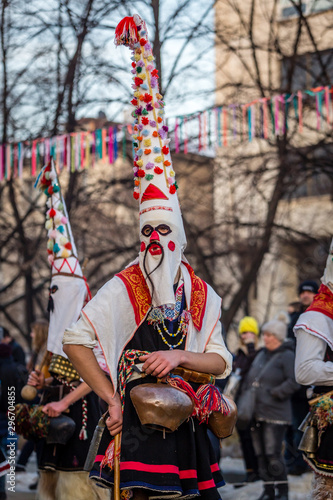 Mummers perform rituals to scare evil spirits at Surva festival at Pernik in Bulgaria. The people with the masks are called Kuker (kukeri). Masks with mustaches. © Chavdar Lungov