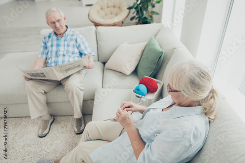 Above high angle view of his he her she two nice focused concentrated people sitting on divan having rest relax spending free time in light white interior living-room house